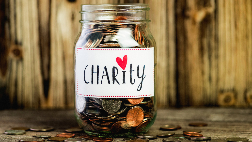 Jar with coins with the word charity written on