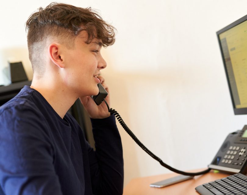 Young man on the telephone in the office