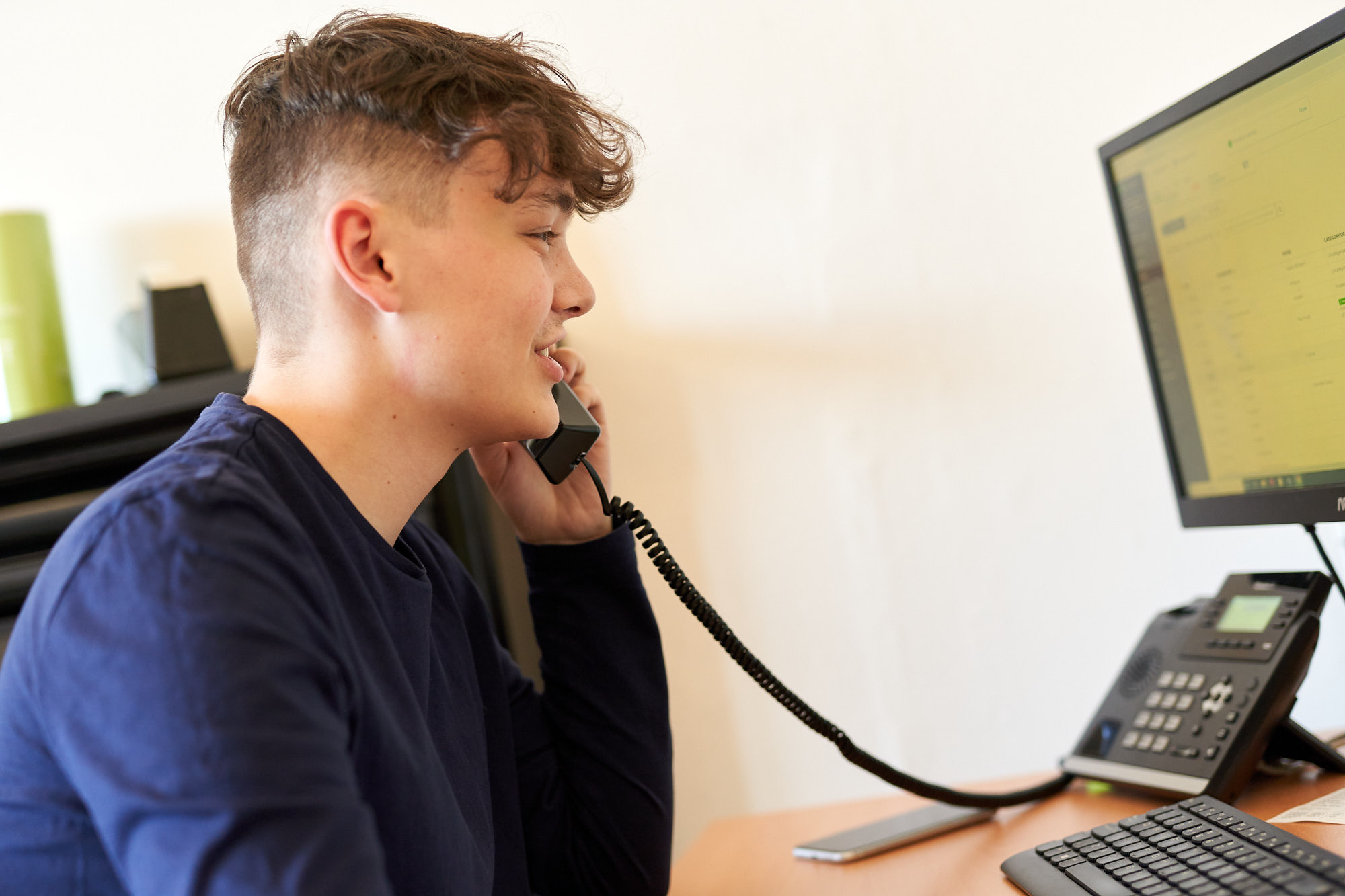 Young man on the telephone in the office