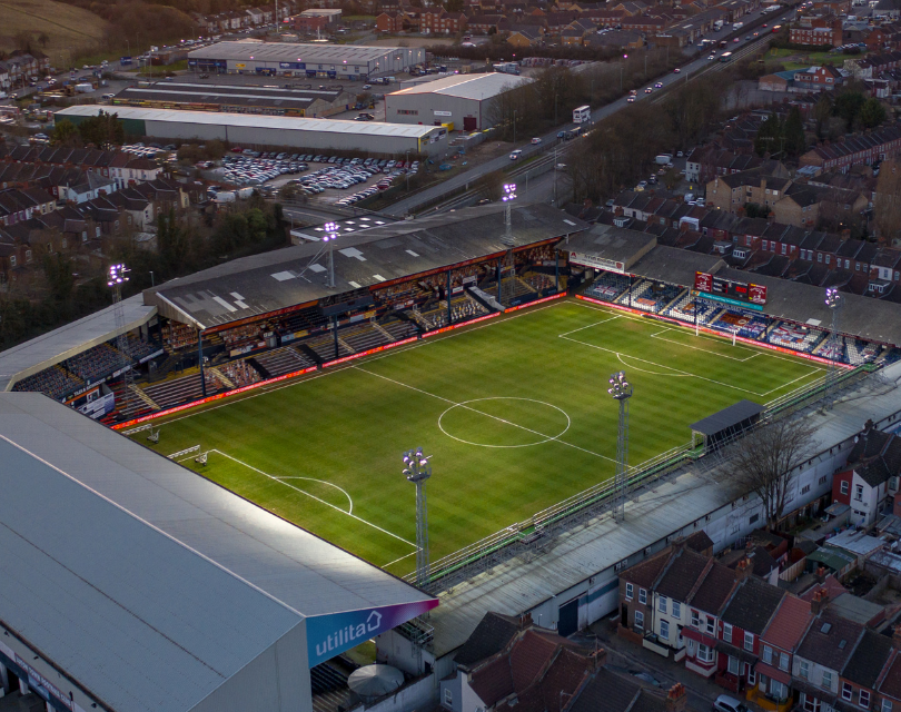 English football ground in evening sunlight