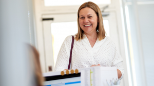 Smiling client arrives at accountancy firm
