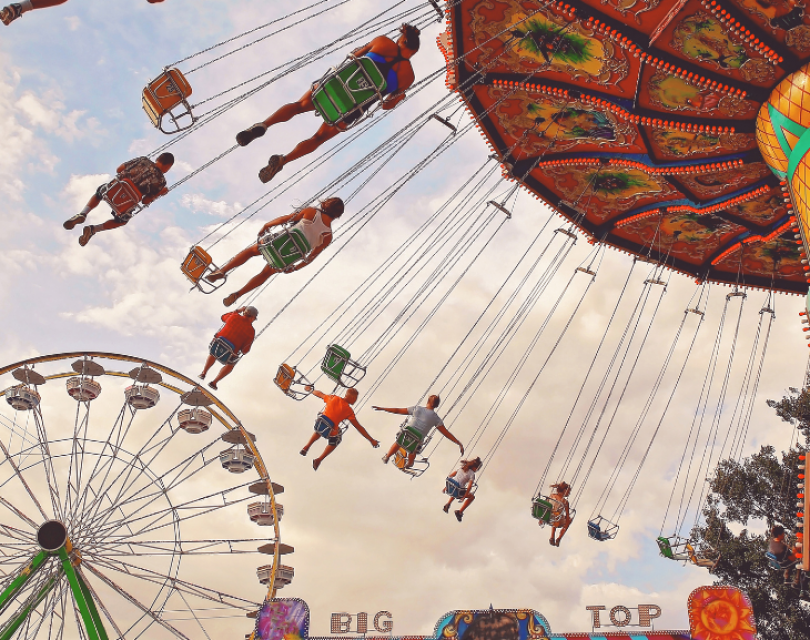 Families enjoy amusement park in the summer